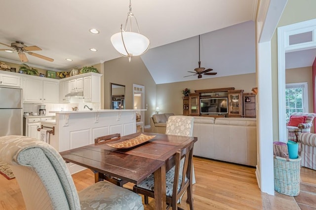 dining room with lofted ceiling, ceiling fan, light wood-type flooring, and recessed lighting