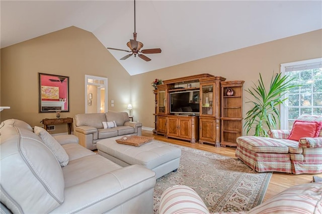 living room featuring light wood finished floors, ceiling fan, and high vaulted ceiling