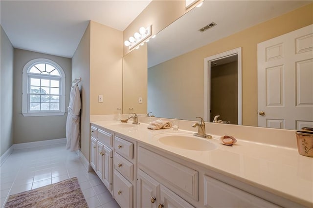 full bath with double vanity, visible vents, a sink, and tile patterned floors