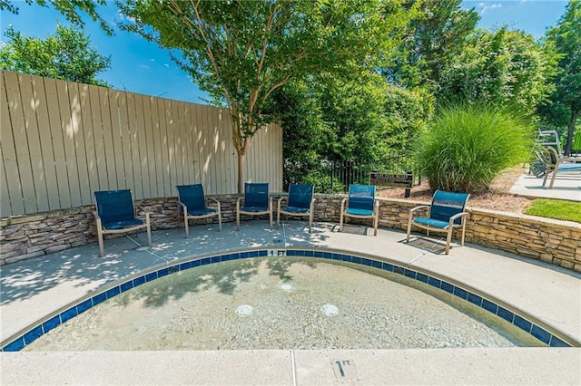 view of pool featuring a patio area and fence