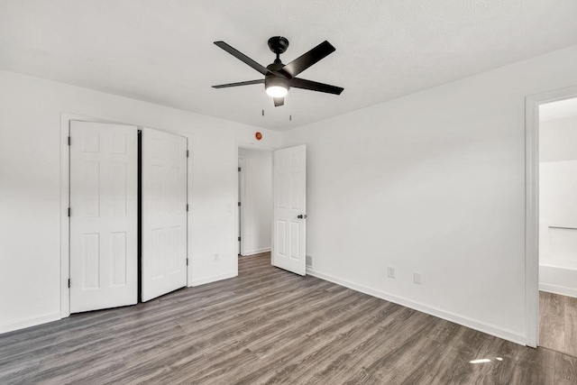 716 Phillips Dr, Monroe, GA 30656 - unfurnished bedroom with wood finished floors, baseboards, a closet, and a ceiling fan