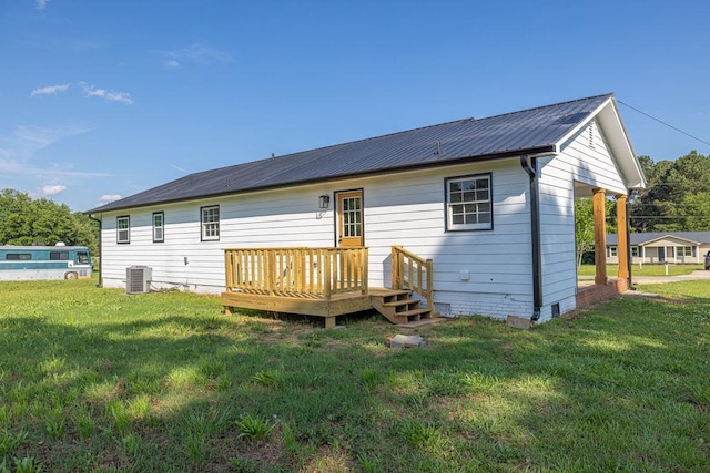716 Phillips Dr, Monroe, GA 30656 - back of property featuring cooling unit, a lawn, a wooden deck, and metal roof