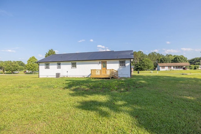 716 Phillips Dr, Monroe, GA 30656 - back of house featuring a lawn, a deck, and central AC unit