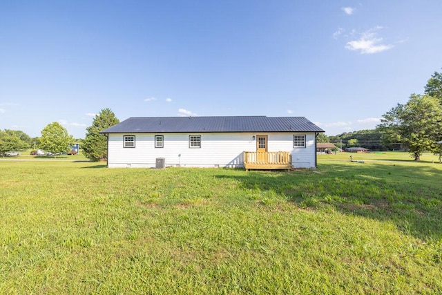 716 Phillips Dr, Monroe, GA 30656 - back of house featuring a lawn, a wooden deck, metal roof, and central AC