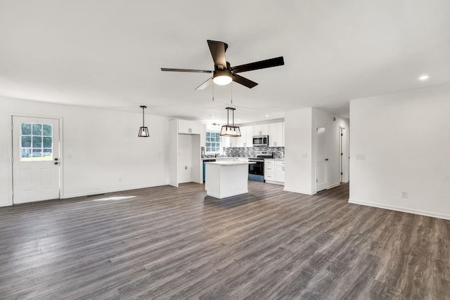 716 Phillips Dr, Monroe, GA 30656 - unfurnished living room with ceiling fan, dark wood-type flooring, baseboards, and recessed lighting