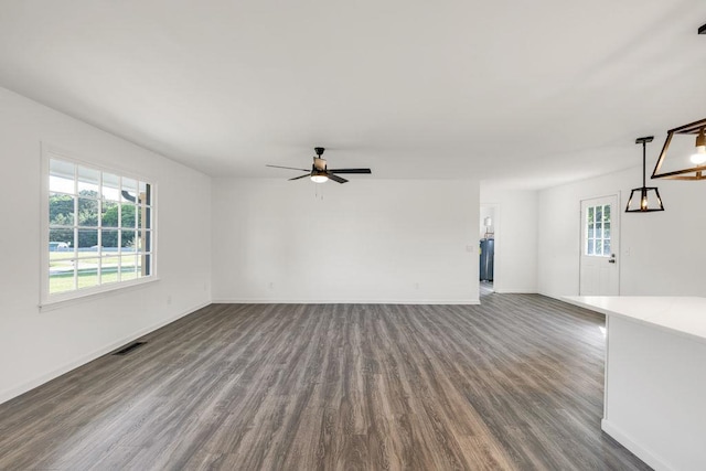716 Phillips Dr, Monroe, GA 30656 - unfurnished living room with dark wood-style flooring, ceiling fan, and baseboards