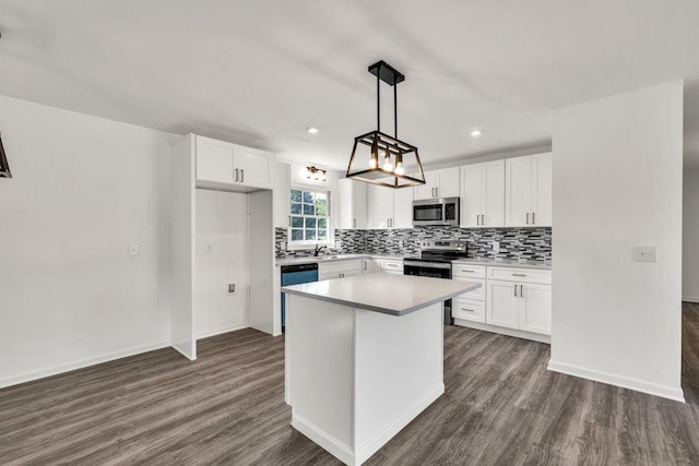 716 Phillips Dr, Monroe, GA 30656 - kitchen with stainless steel appliances, dark wood-style flooring, tasteful backsplash, white cabinetry, and recessed lighting