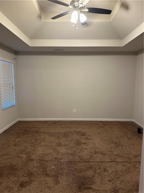 5752 Little River Rd, Atlanta, GA 30349 - empty room featuring a tray ceiling, carpet floors, and ceiling fan