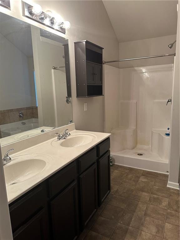 5752 Little River Rd, Atlanta, GA 30349 - full bath featuring lofted ceiling, double vanity, a bath, and a shower stall