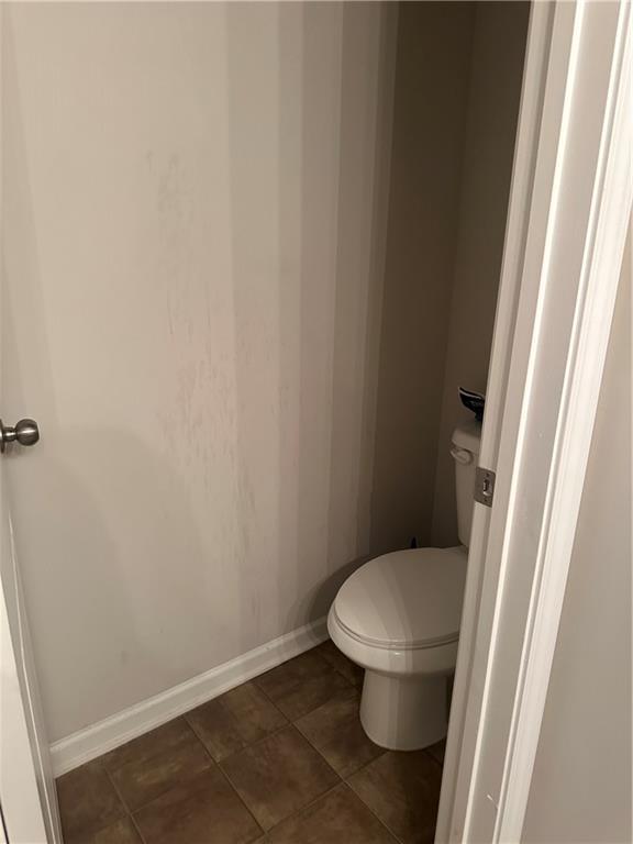 5752 Little River Rd, Atlanta, GA 30349 - bathroom with toilet and baseboards
