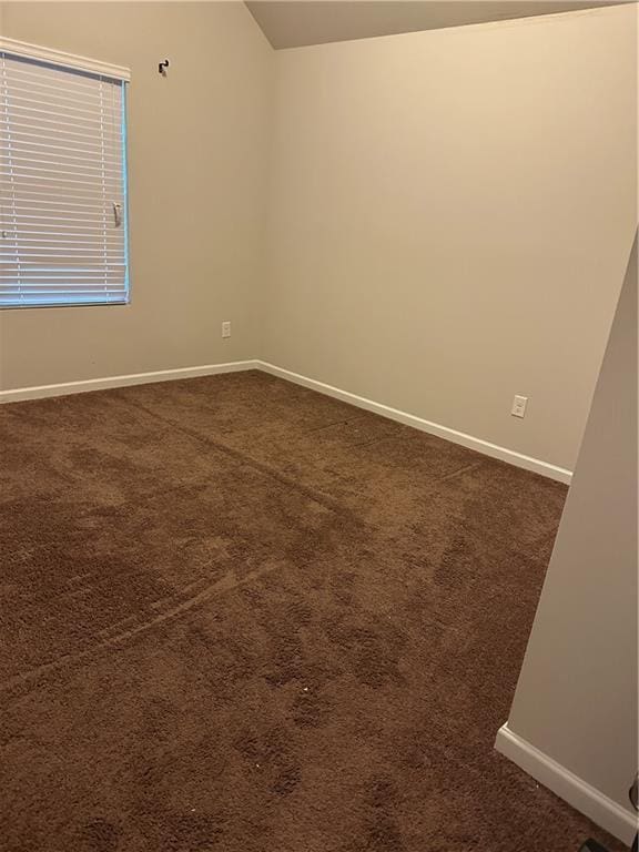5752 Little River Rd, Atlanta, GA 30349 - spare room featuring dark carpet and lofted ceiling