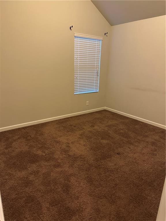 5752 Little River Rd, Atlanta, GA 30349 - empty room featuring vaulted ceiling and dark colored carpet