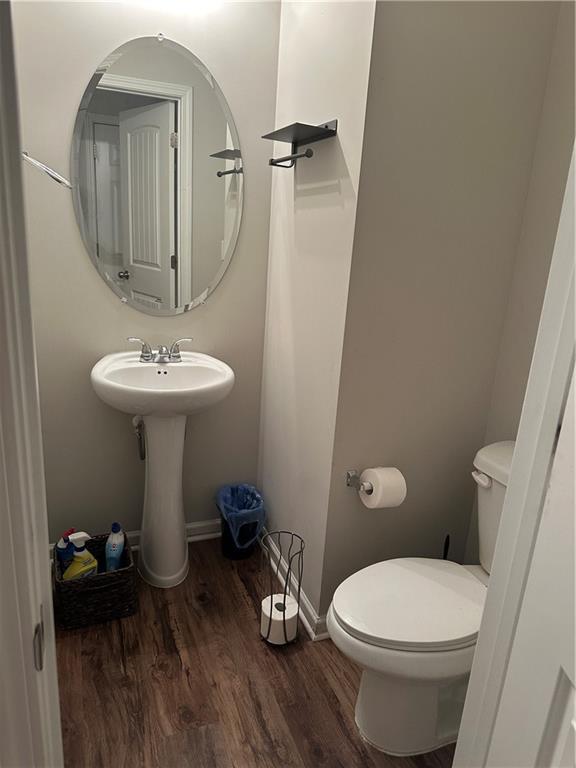 5752 Little River Rd, Atlanta, GA 30349 - bathroom featuring wood finished floors and toilet