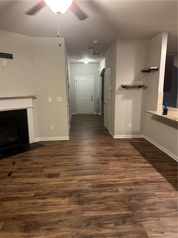 5752 Little River Rd, Atlanta, GA 30349 - unfurnished living room featuring ceiling fan, dark wood-style flooring, and a fireplace