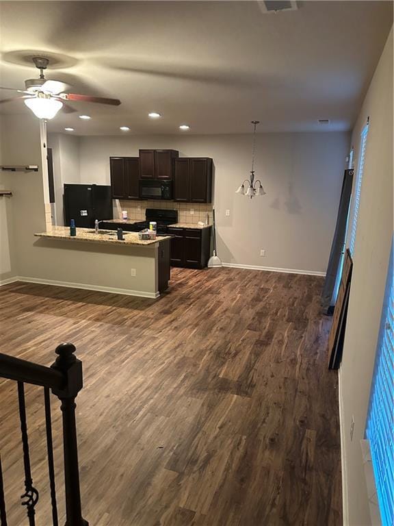 5752 Little River Rd, Atlanta, GA 30349 - kitchen with black appliances, decorative backsplash, a peninsula, dark wood finished floors, and recessed lighting