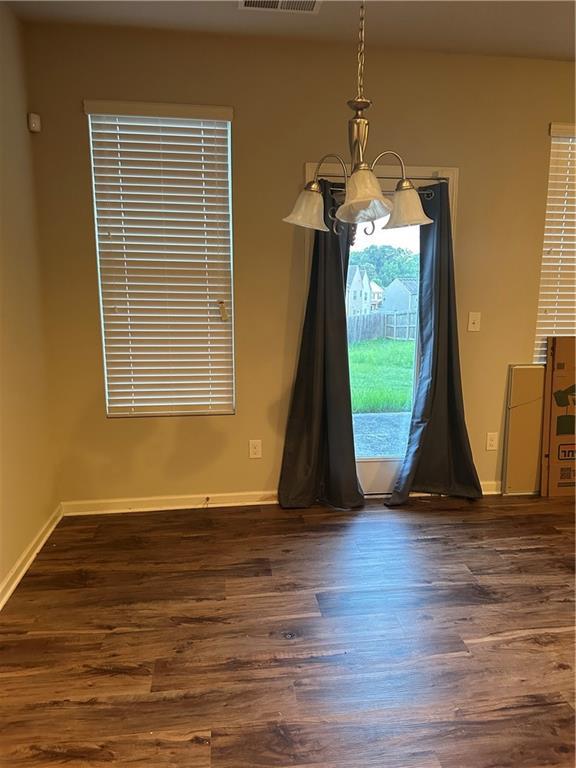 5752 Little River Rd, Atlanta, GA 30349 - unfurnished dining area featuring dark wood-type flooring and a chandelier