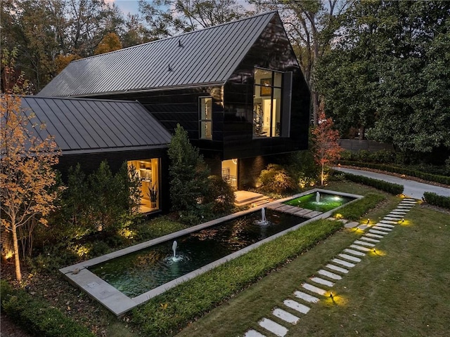 back of house featuring a lawn