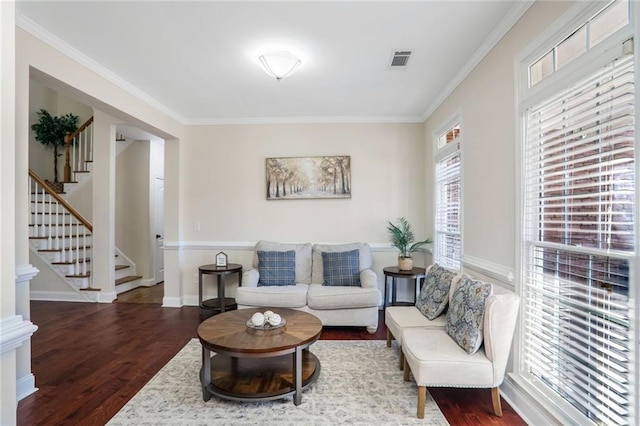 living room with ornamental molding and dark hardwood / wood-style flooring