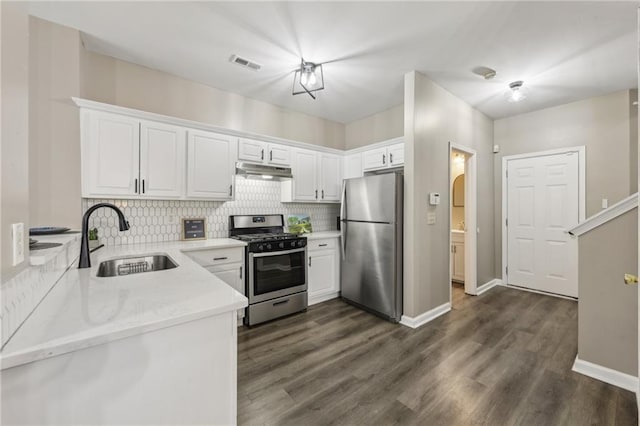 7077 Biltmore Trce, Lithonia, GA 30058 - kitchen with a sink, appliances with stainless steel finishes, under cabinet range hood, and tasteful backsplash
