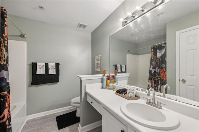 7077 Biltmore Trce, Lithonia, GA 30058 - bathroom with toilet, wood finished floors, baseboards, vanity, and shower / tub combo with curtain