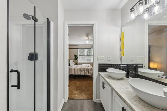 7077 Biltmore Trce, Lithonia, GA 30058 - bathroom featuring a shower stall, ensuite bathroom, wood finished floors, a ceiling fan, and double vanity