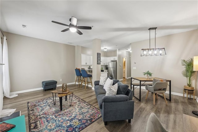 7077 Biltmore Trce, Lithonia, GA 30058 - living room featuring wood finished floors, ceiling fan, and baseboards