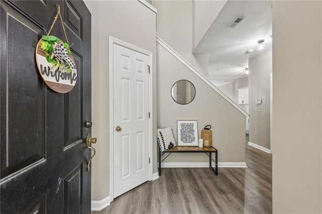 7077 Biltmore Trce, Lithonia, GA 30058 - entrance foyer featuring wood finished floors, baseboards, and stairs