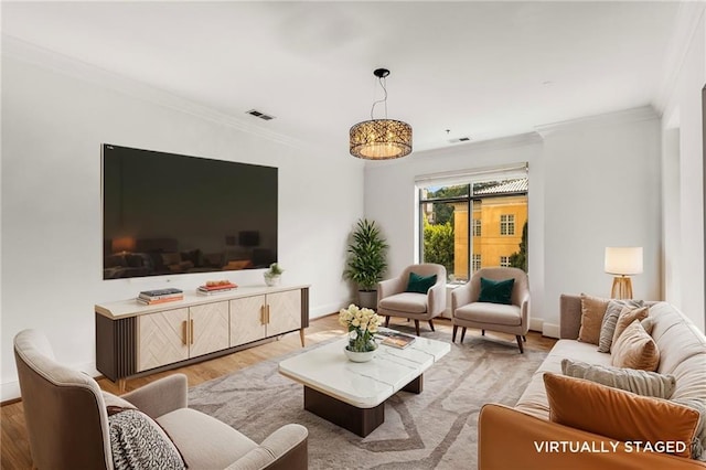 living room featuring light wood-type flooring and ornamental molding