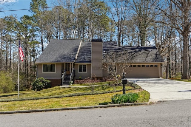 view of front of property with a front lawn, a garage, driveway, and a chimney