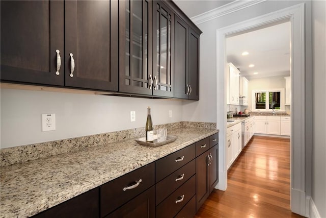315 Melrose Ave, Decatur, GA 30030 - kitchen featuring crown molding, glass insert cabinets, dark brown cabinets, dishwasher, and wood finished floors