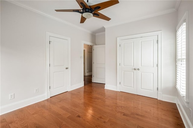315 Melrose Ave, Decatur, GA 30030 - unfurnished bedroom with baseboards, ornamental molding, wood finished floors, and multiple windows