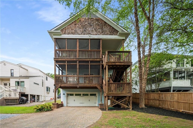315 Melrose Ave, Decatur, GA 30030 - back of house featuring stairs, decorative driveway, an attached garage, fence, and a sunroom
