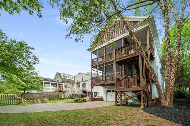 315 Melrose Ave, Decatur, GA 30030 - back of property featuring a sunroom, driveway, stairway, and fence