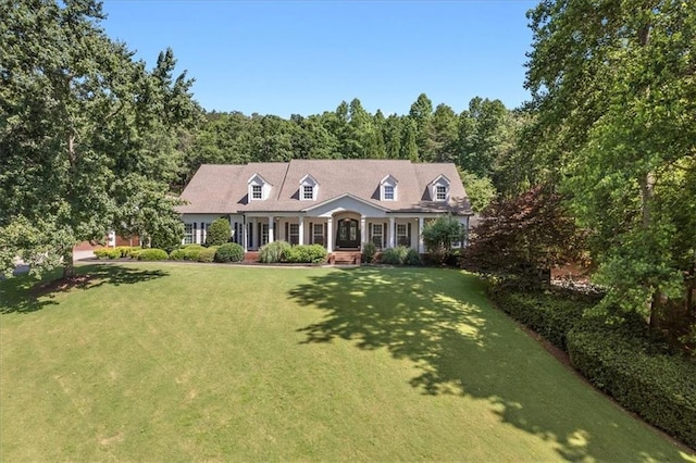 cape cod-style house with a front yard