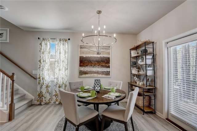 dining room with an inviting chandelier and light wood-type flooring