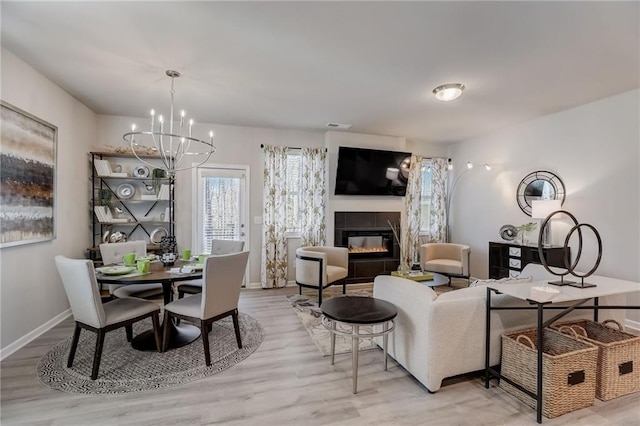 dining space with a chandelier and light hardwood / wood-style floors