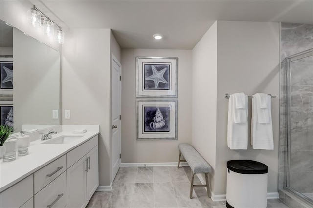 bathroom with vanity and a shower with door