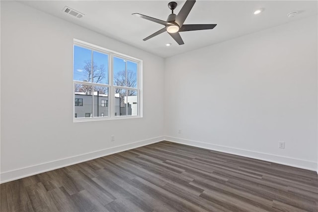 spare room with ceiling fan and dark hardwood / wood-style floors