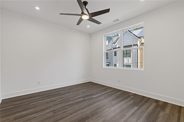 spare room with dark hardwood / wood-style floors and ceiling fan