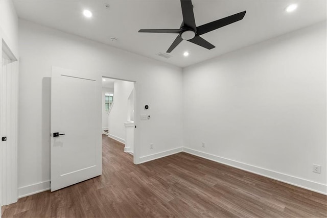 spare room with ceiling fan and dark hardwood / wood-style flooring