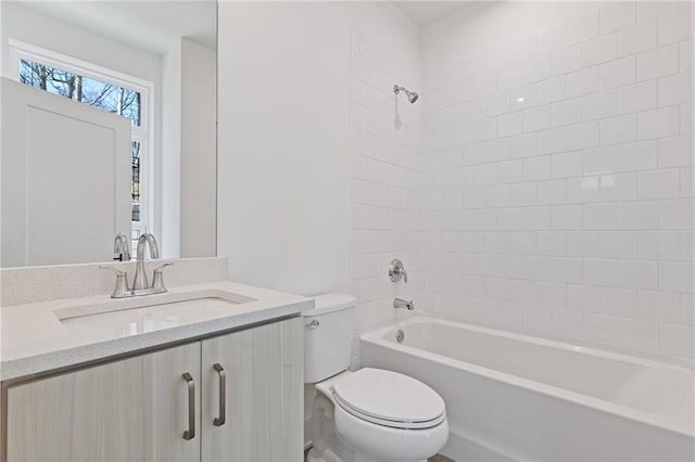 full bathroom with toilet, vanity, and tiled shower / bath combo