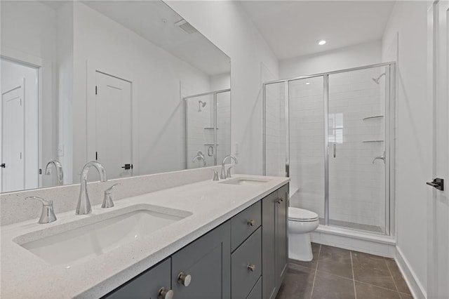 bathroom featuring tile patterned floors, toilet, vanity, and an enclosed shower