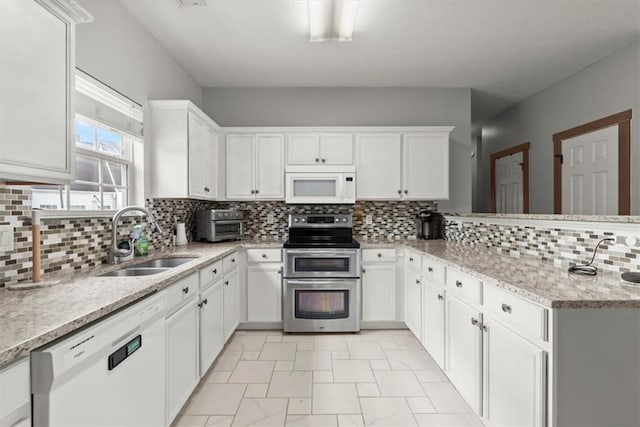 kitchen featuring white cabinets, white appliances, and sink