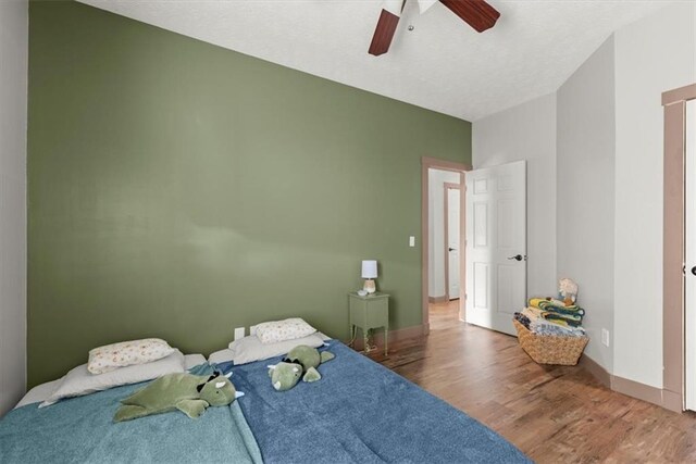 bedroom with hardwood / wood-style flooring and ceiling fan