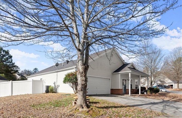 view of property exterior with a garage and covered porch