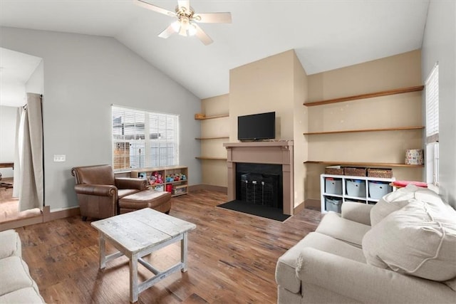 living room with hardwood / wood-style flooring, ceiling fan, and vaulted ceiling