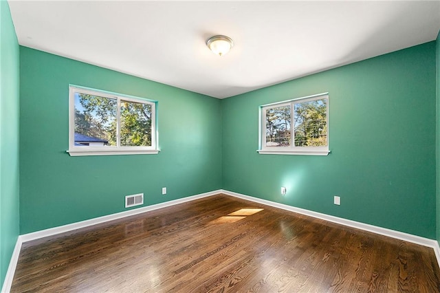 unfurnished room featuring hardwood / wood-style flooring