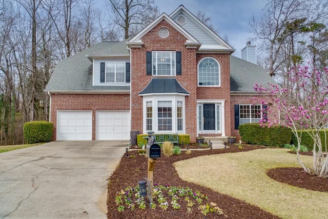 view of front of house featuring brick siding, a shingled roof, a chimney, driveway, and an attached garage