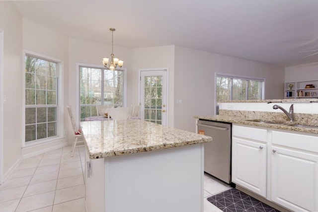 kitchen with stainless steel dishwasher, a center island, light tile patterned floors, and a sink