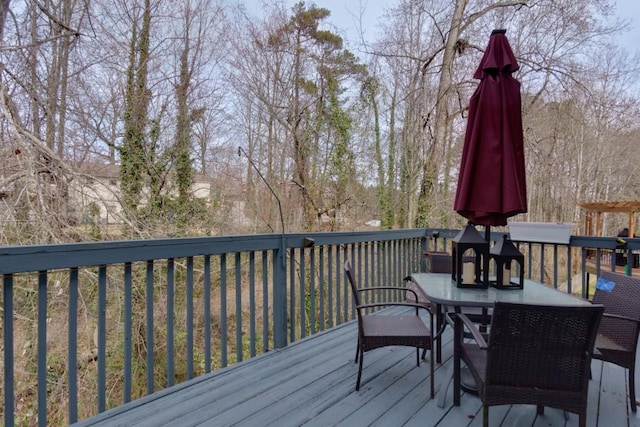 wooden terrace featuring outdoor dining area